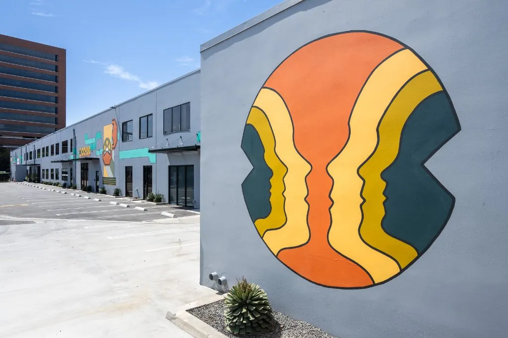 Westgate Media Park exterior, colorful mural and surface parking